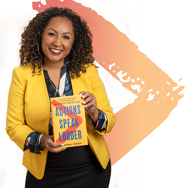 Deanna Singh holding wearing a yellow blazer and holding her book, Actions Speak Louder