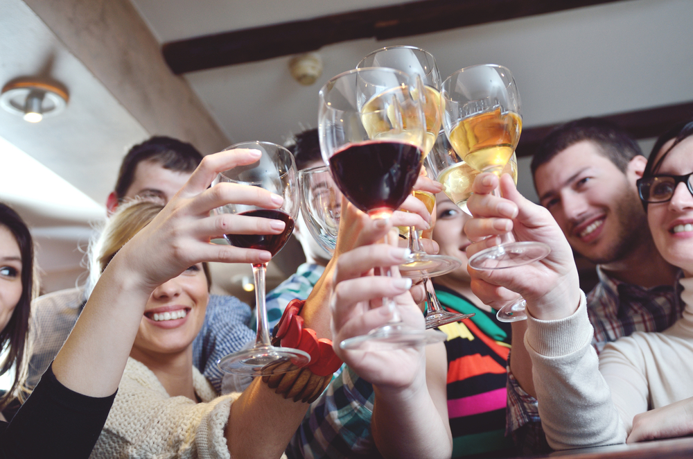 Group of happy young people drink wine at party disco restaurant