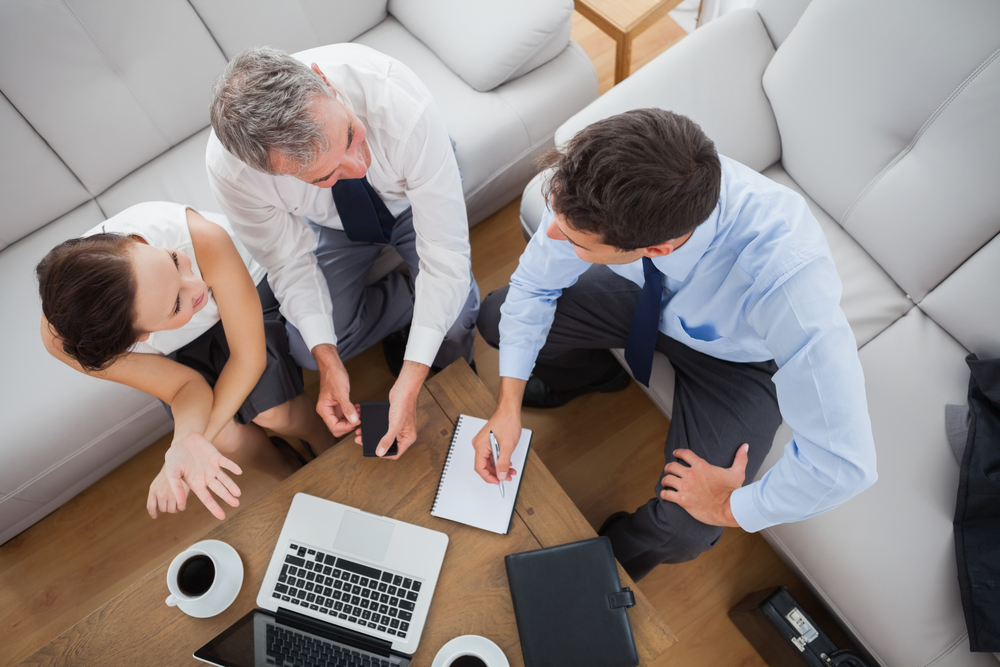 Partners working while having a coffee together in cosy meeting room