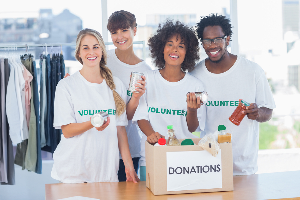 Volunteers taking out food from a donation box in their office