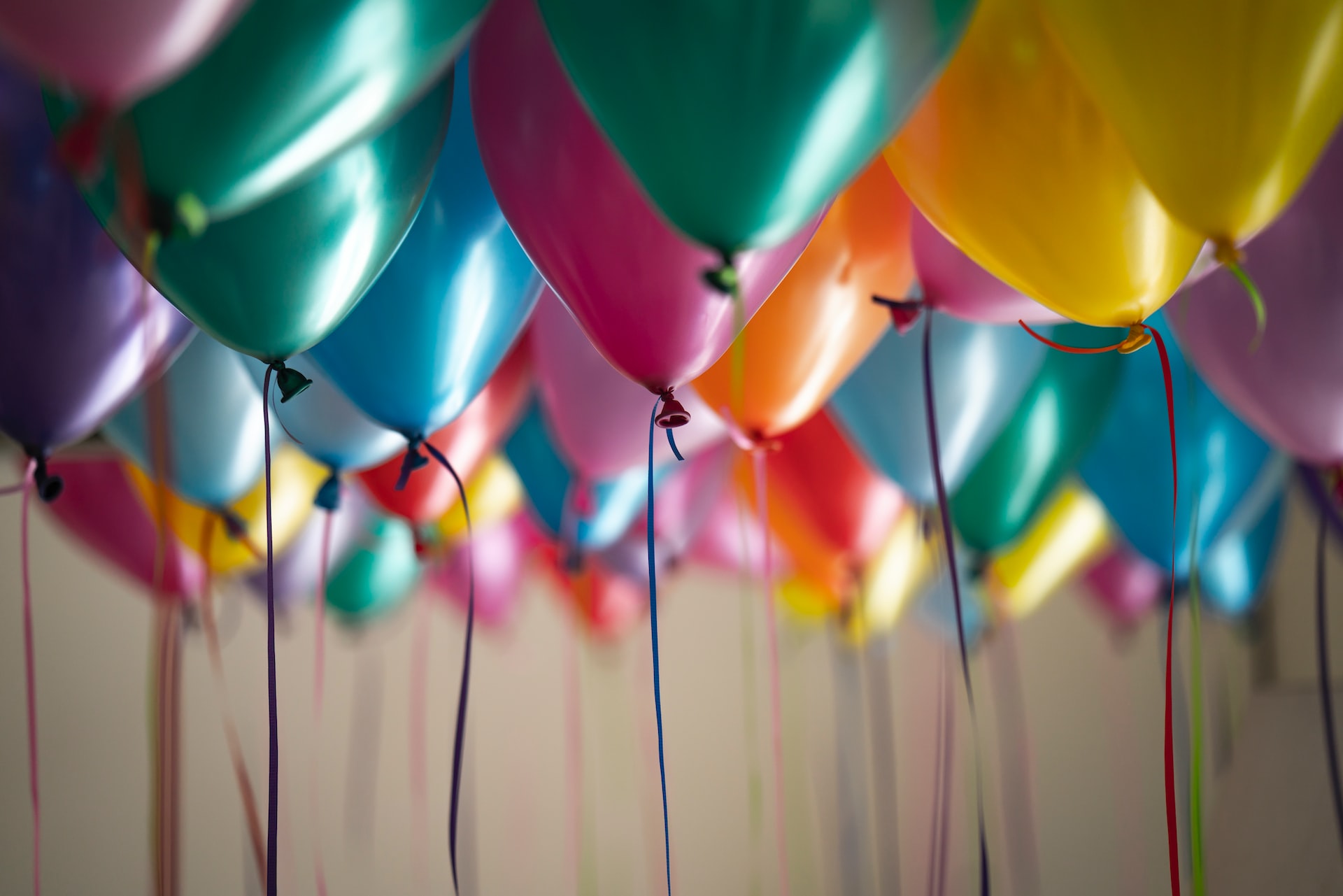 multi-colored balloons hovering near ceiling