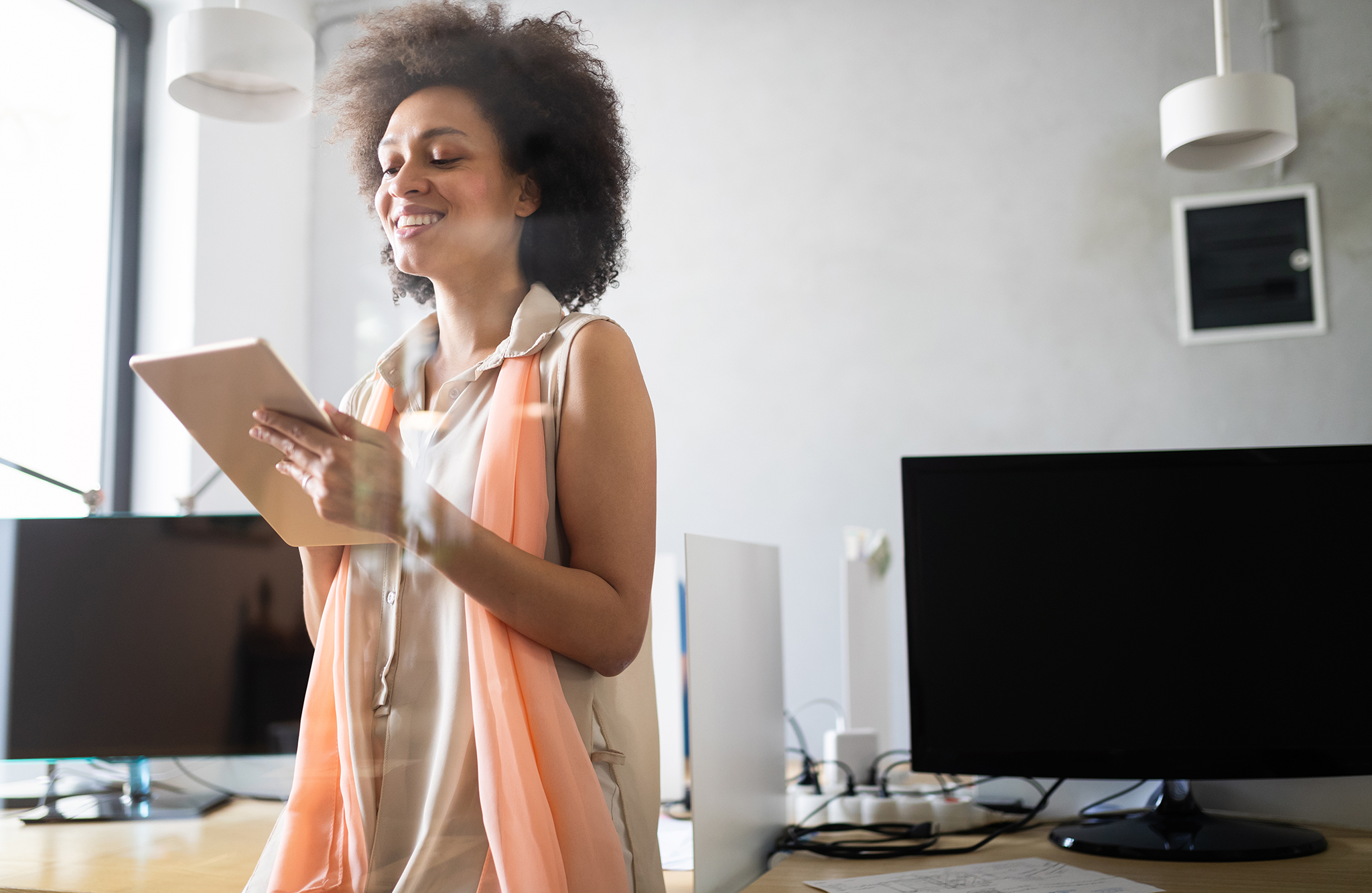 young-african-american-woman-working-with-tablet-XUQJ5DA